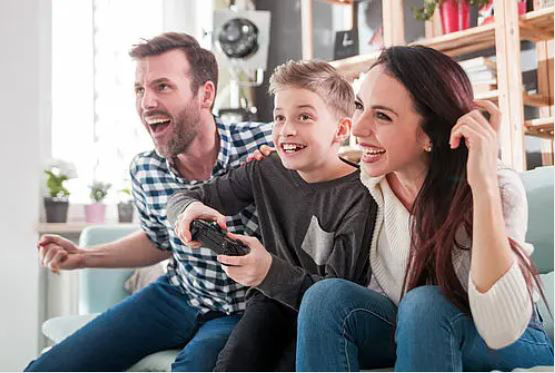 Two adults and their son are playing games together